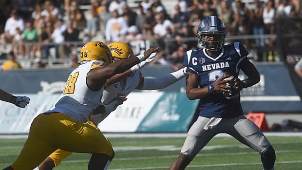 Nevada s Brendon Lewis tries to evade the rush while taking on Idaho at Mackay Stadium in Reno on Sept. 9, 2023.  